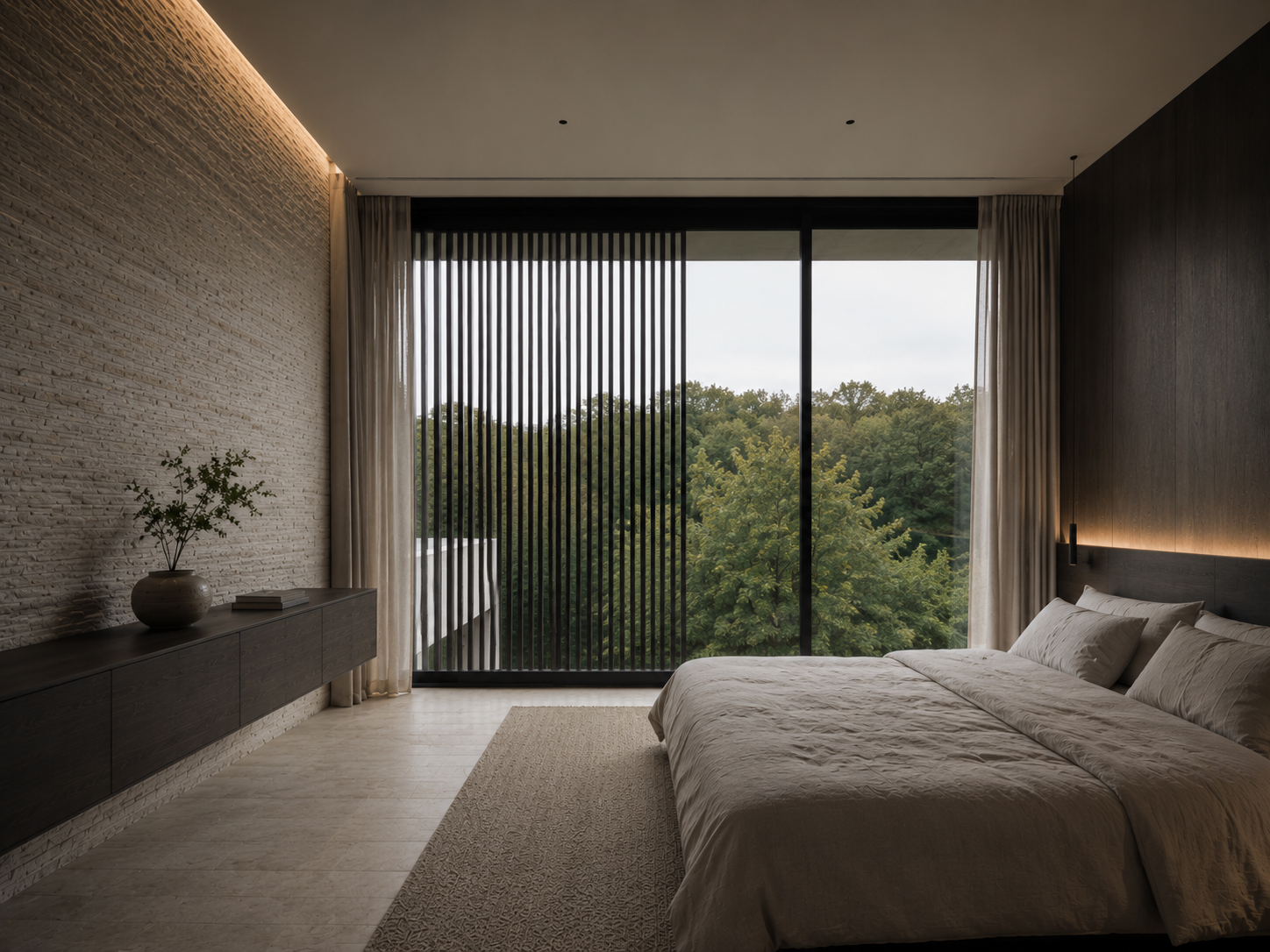 Quiet bedroom with textured stone wall, linen bedding, dark timber headboard, and a full-height window framing the treetops