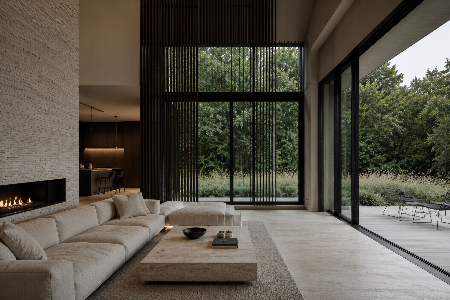 Double-height living room with stone fireplace wall, linen sofa, and vertical timber screen opening to a glazed wall and outdoor deck